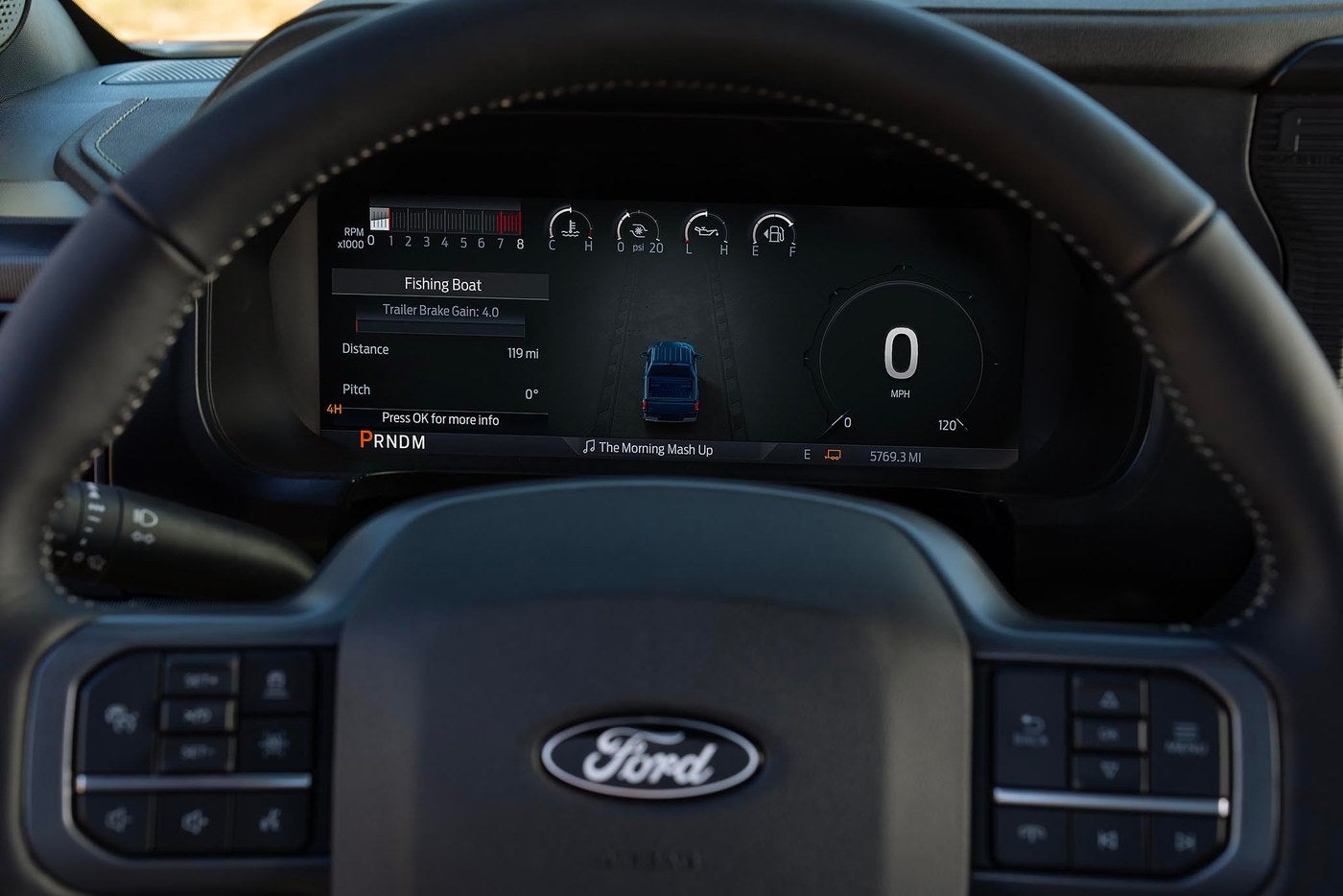 Ford F-150 digital instrument cluster showing trailer brake gain and trailer settings behind the steering wheel