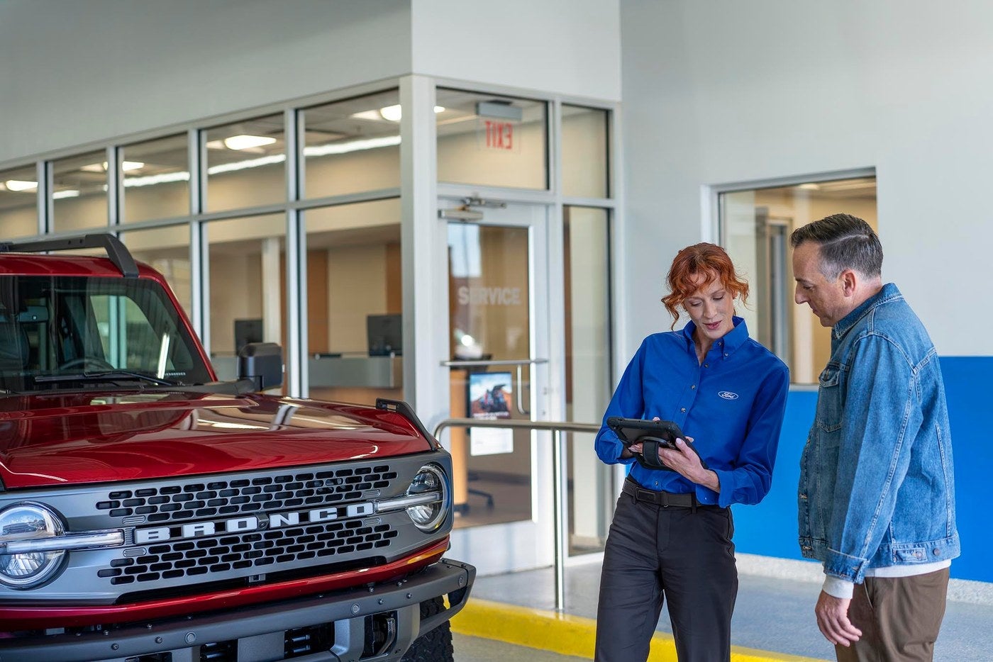 Ford service advisor reviewing a maintenance schedule with a customer, the first step in Ford warranty work in Gordon, TX
