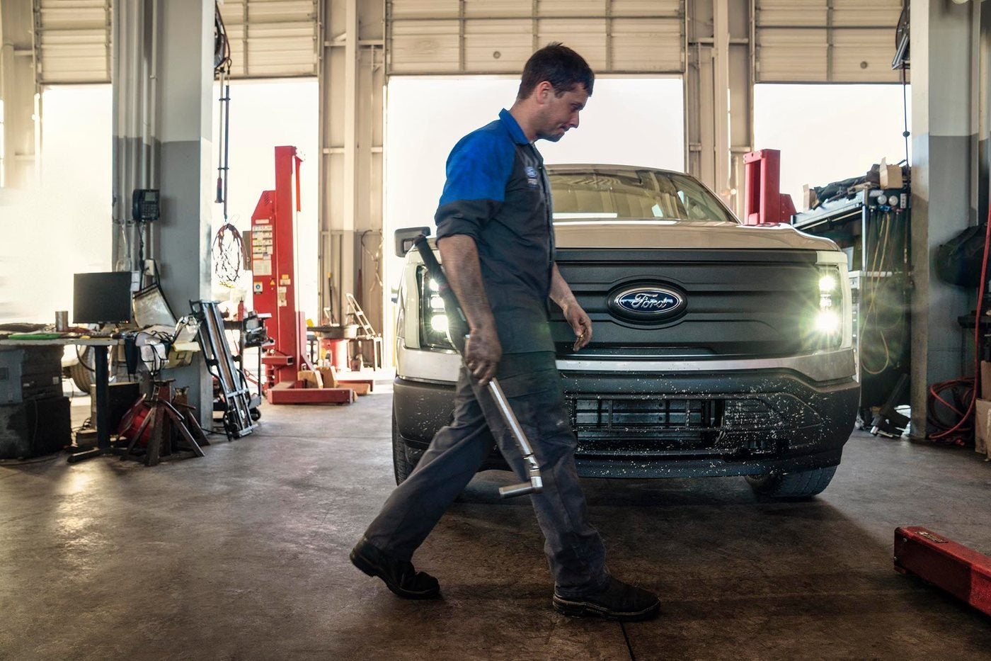 Ford service technician at work on a vehicle