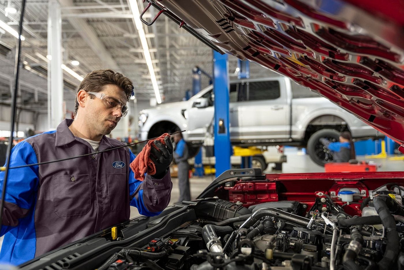 Ford service technician checking the oil level on a Ford vehicle during an oil change visit in Gordon, TX