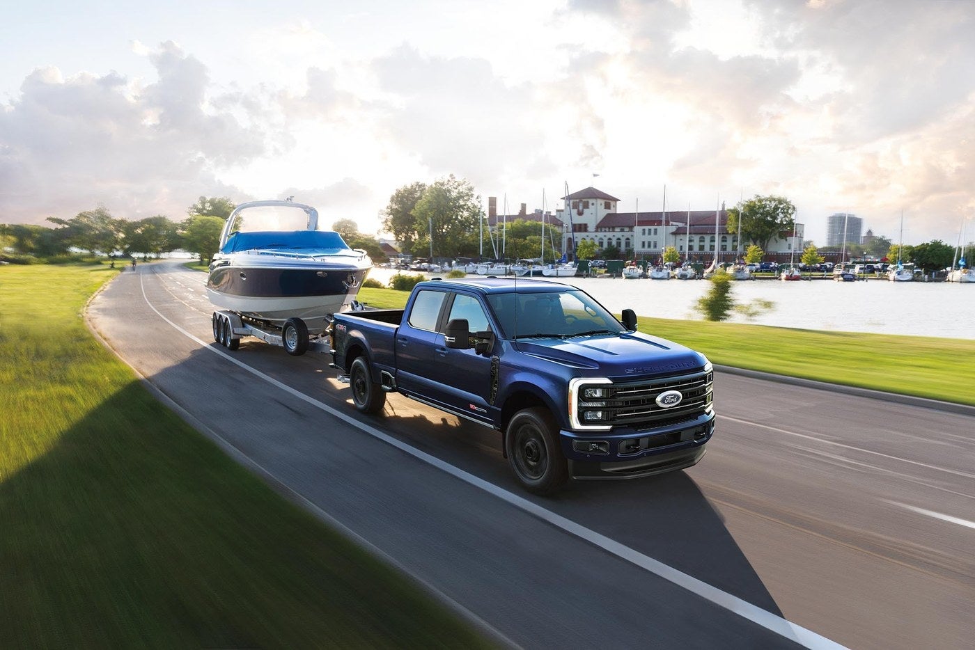 Ford Super Duty F-350 Platinum towing a speed boat down a paved road